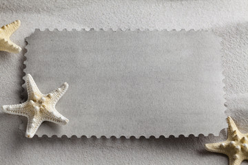 Fototapeta na wymiar Blank paper sheet and starfish on beach sand