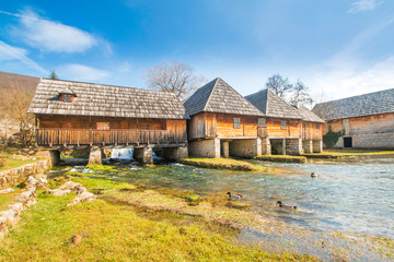     Old wooden water mills in on Majerovo vrilo, source of Gacka river, Lika, Croatia 