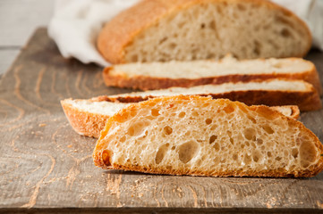 Freshly baked homemade bread on a wooden table. Close up.