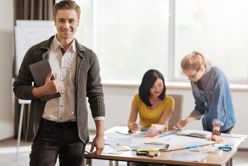 Handsome happy man holding a tablet