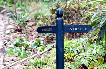 Traditional blue wooden sign pointing to 