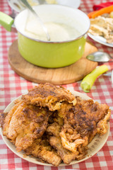 Served table for lunch with dill sauce and panned steaks.