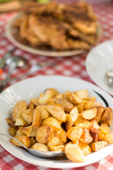 Fried young potatoes served on the lunch table.