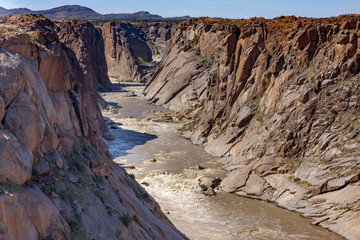 The Orange River winds down the canyon downstream of the Augrabies Falls. After the narrow gorge of the falls, the river gradually widens into a spectacular canyon.