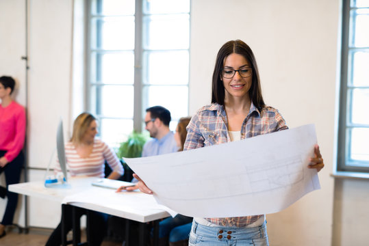 Female designer in office working on architects project