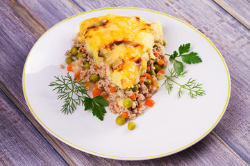 Meat, potato, cheese, carrot, onion and green peas casserole. Traditional shepherd pie