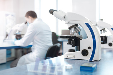 Modern microscope standing on the table