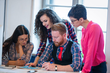 Coworkers working on project together in office