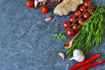 Food background with different ingredients on a marble background. Cherry tomatoes, rosemary, garlic, pepper, lime. Top view.