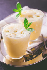 Traditional Indian mango lassi with cardamon, mint, vanilla and saffron
