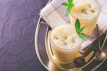 Traditional Indian mango lassi with cardamon, mint, vanilla and saffron