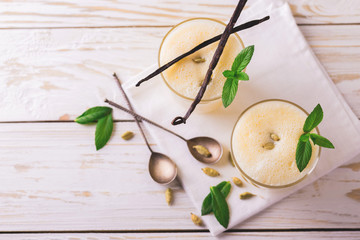 Traditional Indian mango lassi with cardamon, mint, vanilla and saffron