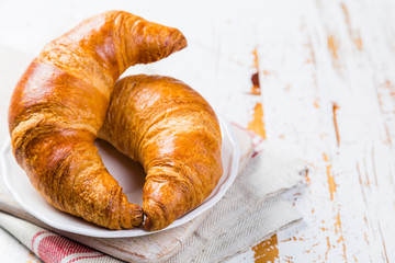 Croissants on rustic wood background