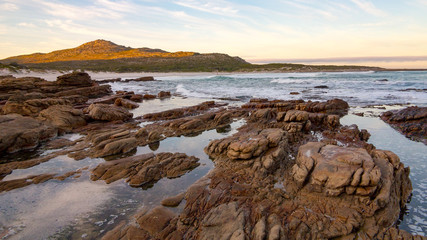 Early morning tide and surf at Scarborough on the Cape Peninsula in South Africa.  This photograph is a wide-angle shot of the rocks and surf on a calm morning.