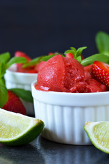 Strawberry ice cream with mint and lime on an old grunge background. Summer dessert.