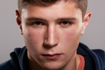 Teenage boy with serious expression, close up