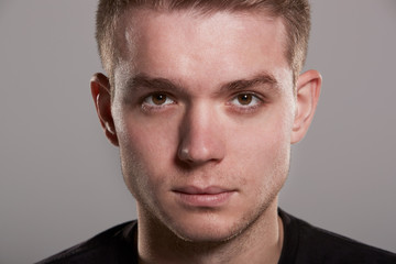 Fototapeta premium Young white man looking to camera, close up head shot