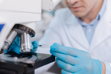 Attentive scientist looking into ocular