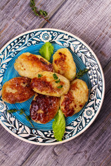 Fish patties or cakes on blue plate. Fritters of fish. Healthy snack or take-away lunch bites. View from above, top studio shot