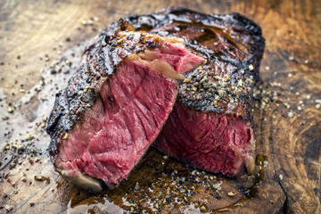 Fototapeta na wymiar Barbecue aged Wagyu Rib Eye Steak as close-up on a wooden board
