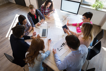 Coworkers working on project together in office