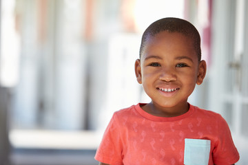Portrait Of Male Pupil Outside Classroom At Montessori School
