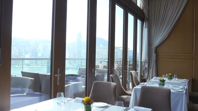Fine Dining Restaurant 4K. 
Fine dining restaurant with large windows and by the sea view.
Wide tilt down shot. 
