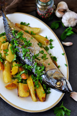 Baked mackerel with potatoes and spices for dinner