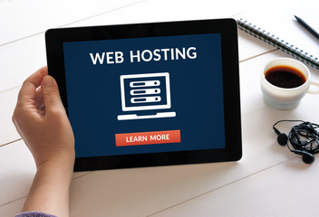 Hand holding digital tablet computer with web hosting concept on screen. All screen content is...