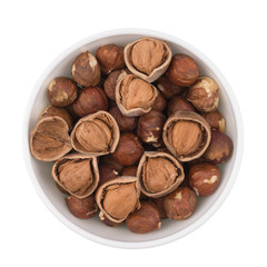Hazelnut in a white bowl. Isolated on white background.