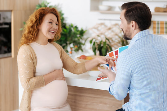 Adorable mother-to-be chatting with husband