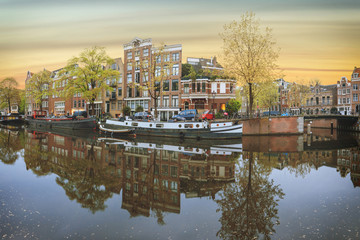 Fototapeta na wymiar Canals of Amsterdam. Moody panorama of Rossebuurt district