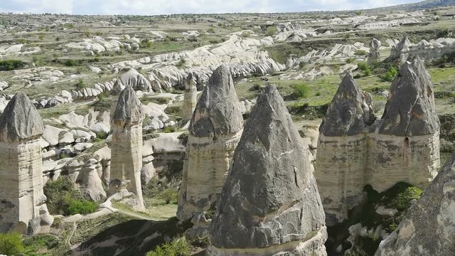 Amazing view of Turkish fortress Uchisar in the Cappadocia, Turkey. Cappadocia with its valley, ravine, hills, located between the volcanic mountains in Goreme National Park.