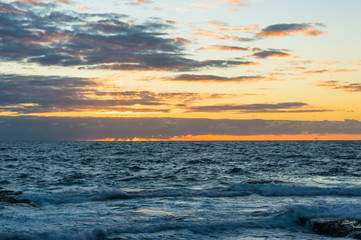 Ocean landscape with sunrise sky on the background