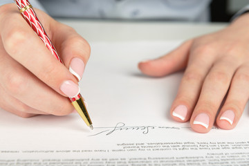 Woman hand signing a contract