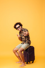 Full length portrait of a cheerful young african tourist guy