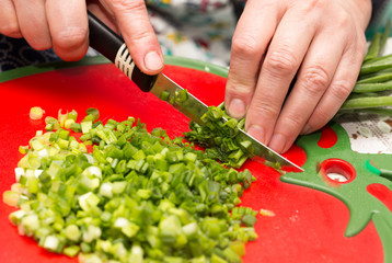 Cook cuts green onions with a knife