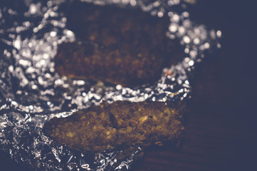 kofta kebabs on aluminum foil paper, selective focus