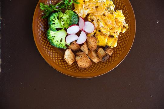 Home made fresh omelette for breakfast with vegetables vitamins. Broccoli omelette breakfast background. Fresh omelette with vitamins on plate.