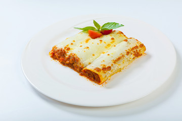 italian lasagna rolls on a white plate