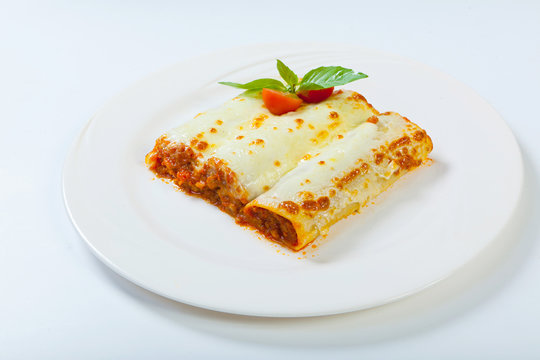 Italian Lasagna Rolls On A White Plate