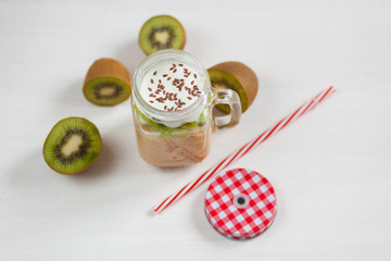 Fresh healthy fruit smoothies from kiwi, banana, pear and apple in a jar on a white background. Soft focus. Vegetarian food