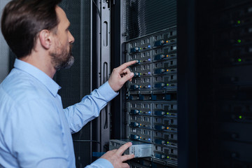 Nice bearded man setting up the network server