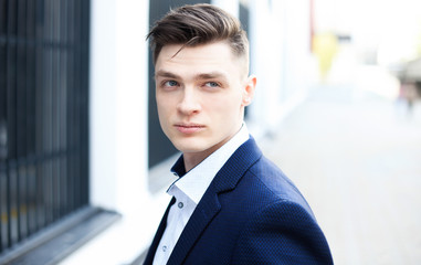 Cropped portrait of a handsome businessman standing outside.