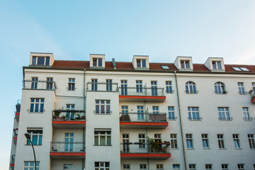 white building with red and small balconies