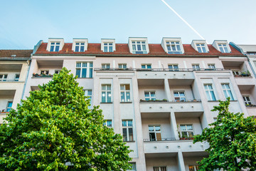 apartment house in rose colors with green fresh tree