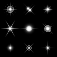 Set of sparkling white stars on black