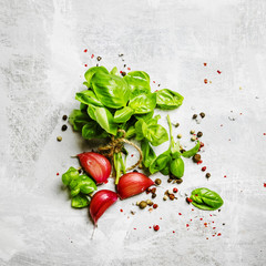 Food background, green basil, garlic, salt and pepper, top view