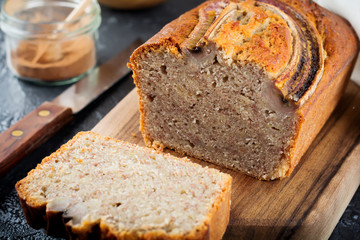 Banana bread and bananas on a dark background. Top view. Selective focus.