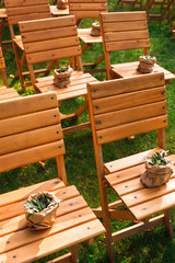 Wedding ceremony, empty wooden guest chairs